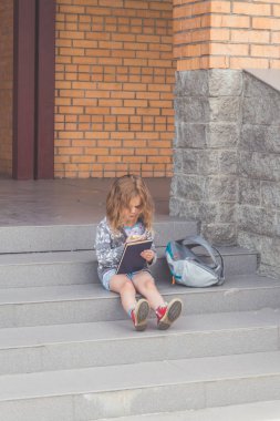 Güneşli bir günde okul, anaokulu geri kalan kız, bir çocuk tatilde de sokakta