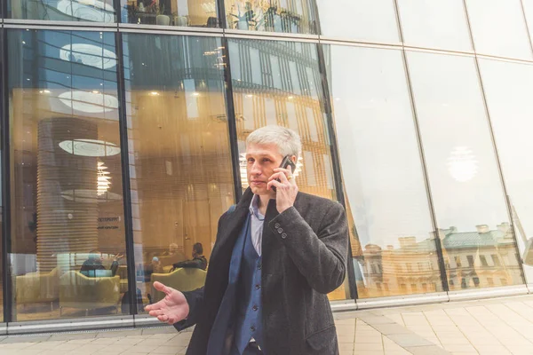 man, a businessman outside the office on the street with the phone