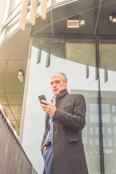 man, a businessman outside the office on the street with the phone