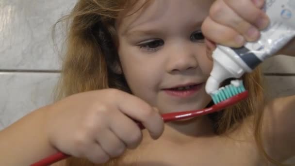 Bir Kız Onun Fırçalarken Diş Macunu Ile Banyoda Bebek — Stok video