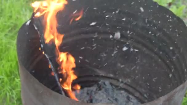 A metal barrel they burn paper and wood garbage burns coal and flies ash — Stock Video