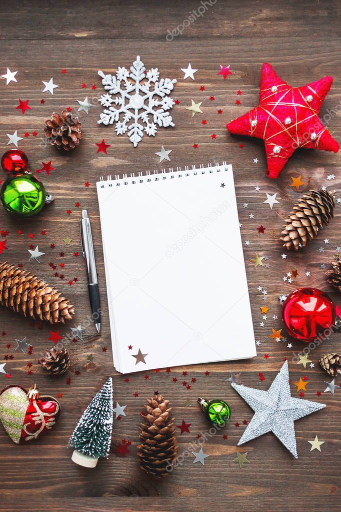 Christmas and New Year background with notepad, pen and decorations. To do list or list of promises, place for your text. Mock up.
