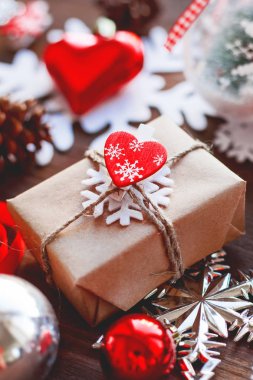 Noel ve yeni yıl arka plan sunar, kurdeleler, topları ve ahşap arka plan üzerinde farklı süslemeler ile. Hediyelik oyuncak kalp, aşk sembolü.