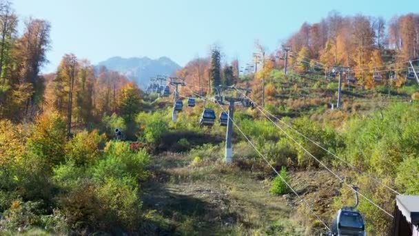 Rosa-khutor, russland - 13. oktober 2018. fahrende kabinen der seilbahn. Seilbahn fährt über Bäume an Berghängen. — Stockvideo
