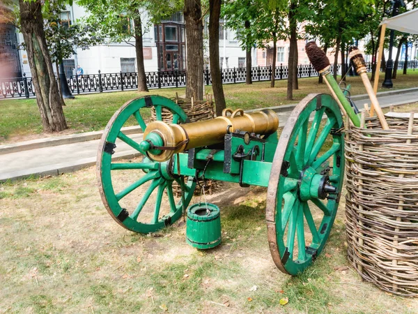 Ancient cannon, firing iron cores. Old weapon on historical festival Times and Epochs. Moscow, Russia.