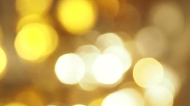 Defocused light reflections of golden sparkling fabric. Blurred colorful bokeh background — Stock Video