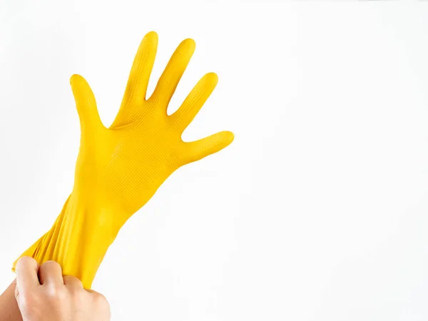 Woman is wearing yellow rubber glove. Isolated symbol of good cleaning service or using protective gloves while cleaning. — Stock Photo, Image