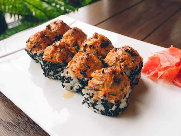 Rollos con anguila, hongos shiitake, sésamo negro, salsa picante, salsa unagi, jengibre en escabeche. Cocina asiática, plato tradicional - sushi . — Foto de Stock