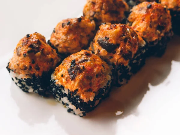 Rolls with eel, shiitake mushrooms, black sesame, spicy sauce, unagi sauce, pickled ginger. Asian cuisine, traditional dish - sushi.