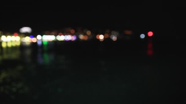 Panorama view of Yalta town from the Black sea. Night life on embankment. Defocused lights. Crimea — Stock Video