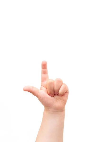 Mano de niño sobre fondo blanco. El niño señala algo con su dedo índice. Plano, vista superior, copyspace . — Foto de Stock