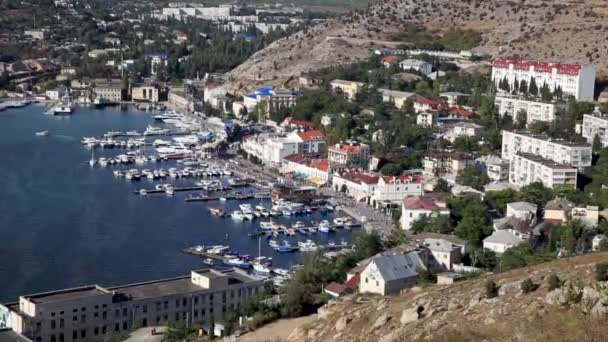 Panorama view of Balaclava from ancient fortress Chembalo. Balaclava Bay with yachts in bright sunny day. Crimea — Stock Video