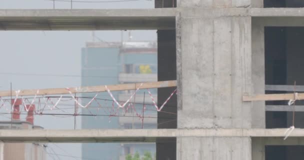 Construction site in winter under snow. Open spans are tied with plastic restrictive tape. — Stock Video