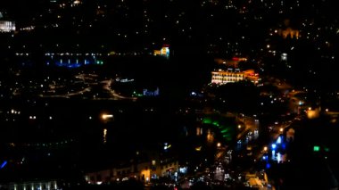 Gürcistan ülkesinin başkenti Tiflis gece panorama görünümü. Aydınlatma ve hareketli araba ışıkları ile karanlık sokaklar.