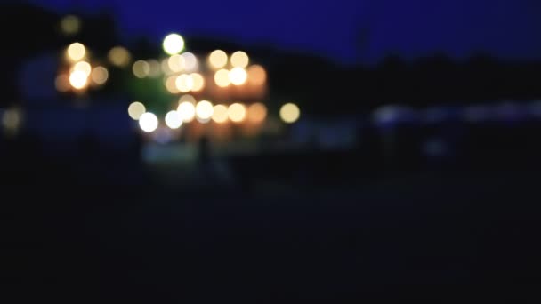 Night view on coast of Sudak town. from the Black sea. Crimea. Defocused background. — Stock Video