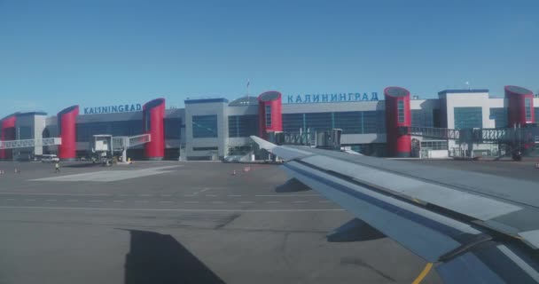 Plane landed at the airport Khrabrovo. View name of the city Kaliningrad on the roof of airport building. Russia. — Stock Video