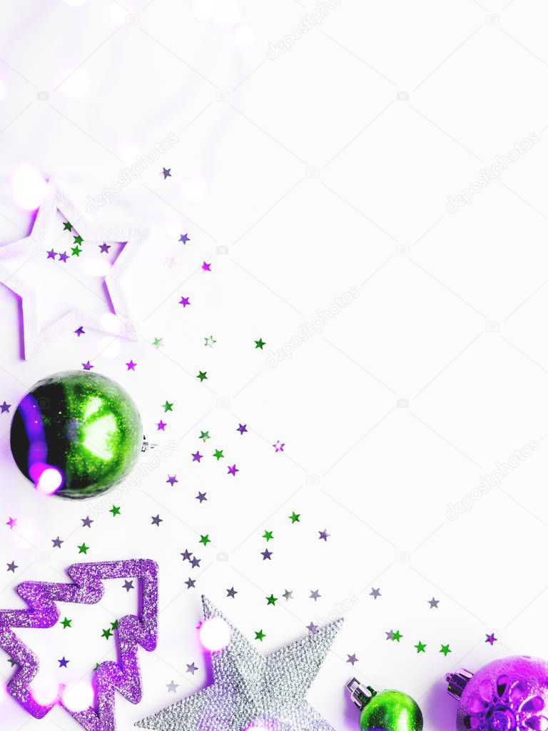 Christmas and New Year background with decorations - green and magenta shiny stars, balls, snowflakes and confetti. 