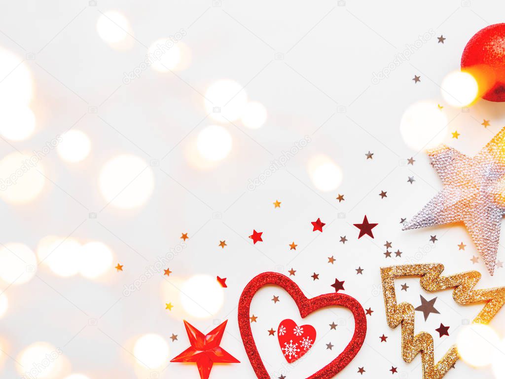 Christmas and New Year background with decorations - shiny stars, balls, snowflakes, heart, confetti and light bulbs. Place for text.