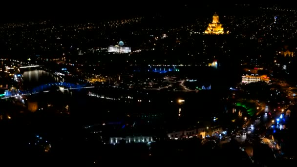 Avond panorama uitzicht op Tbilisi hoofdstad van Georgië land. Metekhi kerk Heilige Drie-eenheid kathedraal Sameba en presidentiële administratie 's nachts met verlichting en bewegende auto' s — Stockvideo