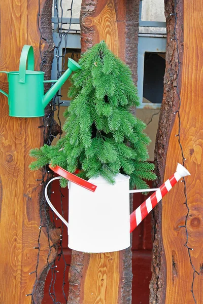 Artificial Coniferous Tree Red White Watering Can Hanging Wooden Fence — Stock Photo, Image