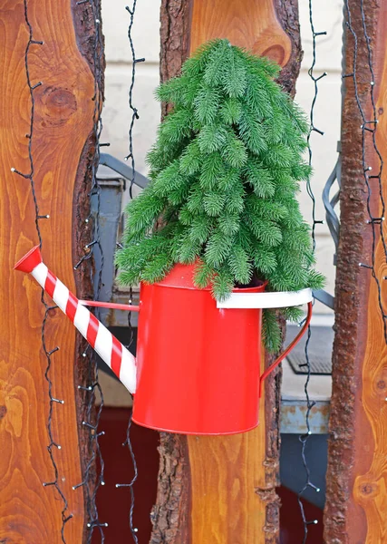 Artificial Coniferous Tree Red White Watering Can Hanging Wooden Fence — Stock Photo, Image