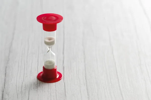 Kum saatinin ampullerinde akan beyaz kum, fotokopi aletiyle birlikte beyaz zemin üzerine geri sayım bitimine kadar geçen zamanı ölçüyor..