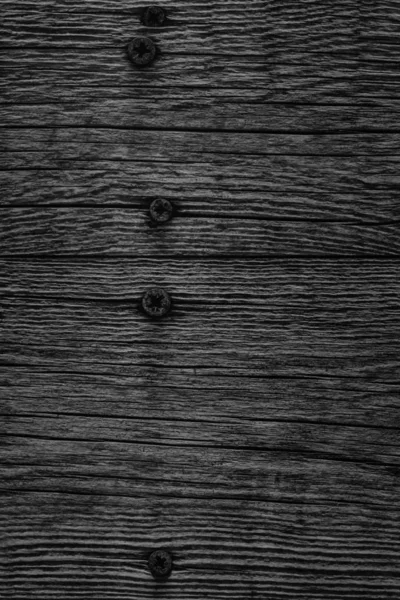 Black Old Weathered Cracked Knotted Pine Wood Floorboards With Rusty Phillips Screws Embedded Detail — Stock Photo, Image