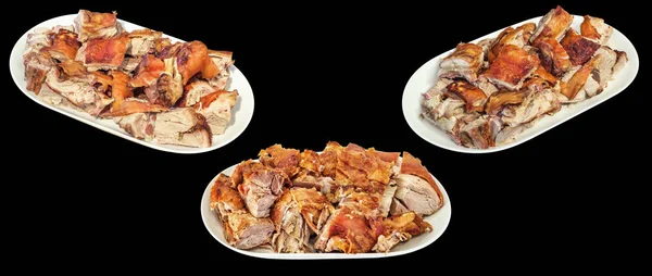 Photograph of traditional gourmet delicious freshly spit roasted pork juicy crunchy succulent meat slices, served on white oblong porcelain platters, isolated on black background.