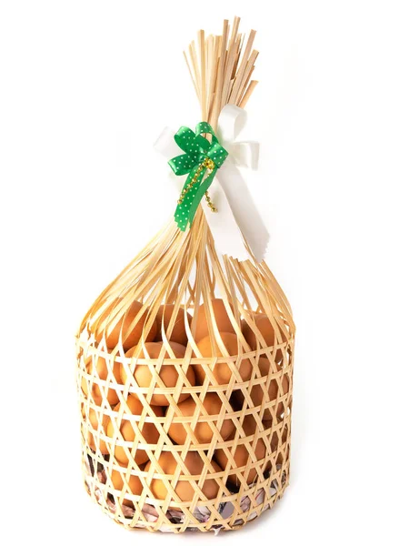 Chicken eggs in a gift basket. — Stock Photo, Image