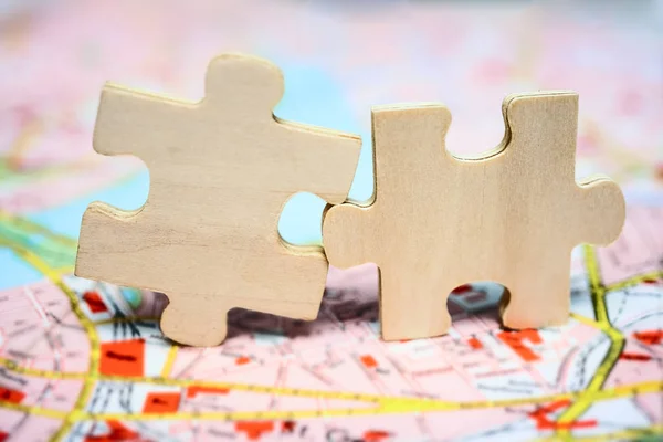 Zwei Puzzleteile Aus Holz Die Auf Einer Landkarte Aus Papier — Stockfoto