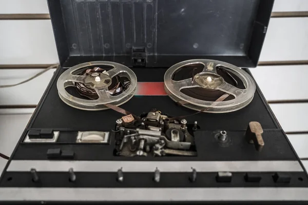 Old reel tape recorder, standing on wooden table, retro style
