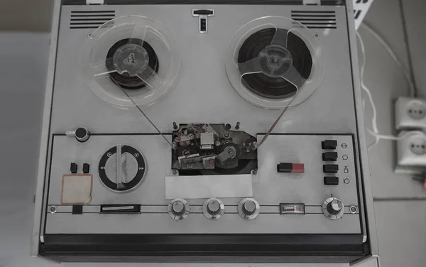 Old reel tape recorder,  on wooden table, retro style.