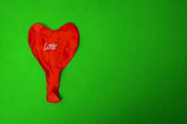red deflated balloon. love word on balloon.