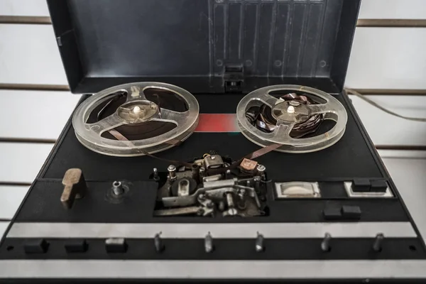 Old reel tape recorder, standing on wooden table, retro style