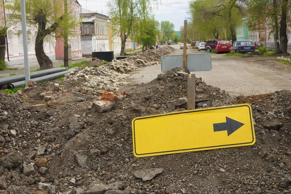 Yellow bypass sign for cars. replacement of pipes on streets of the city — Stock Image Yellow Bypass Sign Cars Replacement Pipes Streets City Royalty Free Stock Images