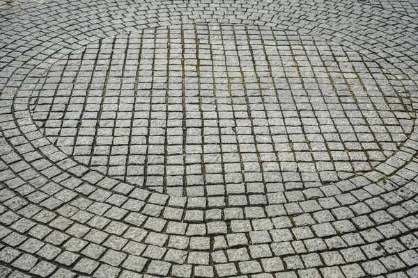 Texture of old cobblestones. City street.