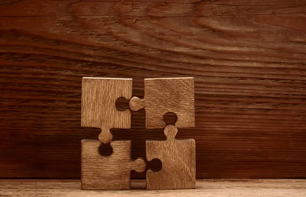 Four Wooden Puzzle Pieces Wooden Background Concept Connection People — Stock Photo, Image