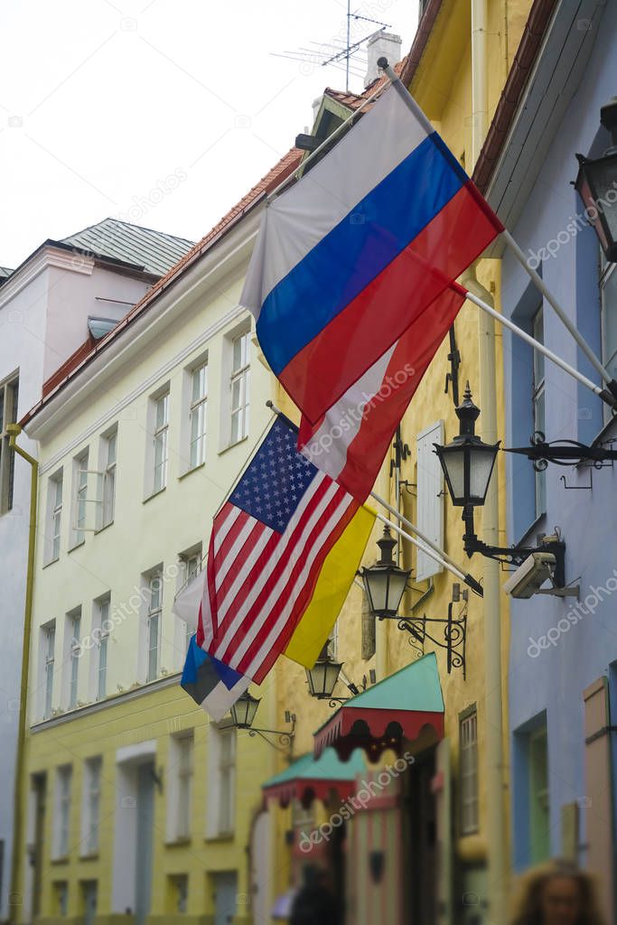Russian, american and austrian  flags hang on Embassy building. Tallin town