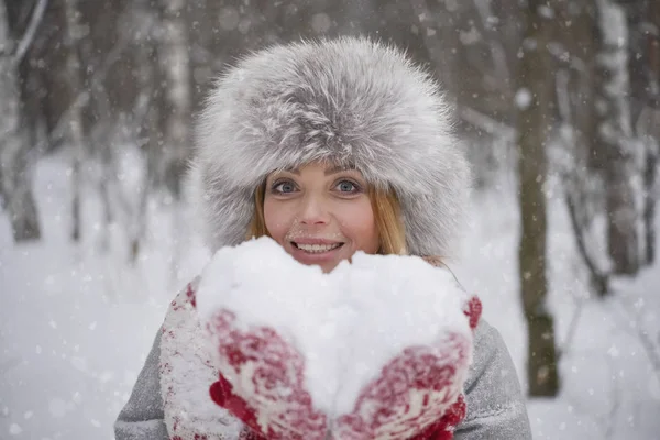 Χιόνι Μορφή Της Καρδιάς Χαρούμενα Ξανθιά Γυναίκα Στο Χειμερινό Καπέλο — Φωτογραφία Αρχείου