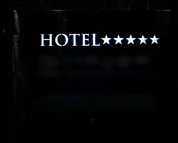 signboard on a four star hotel. night scene. rooms vacan