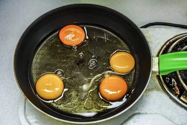 eggs with yolk on frying pan. electric stove