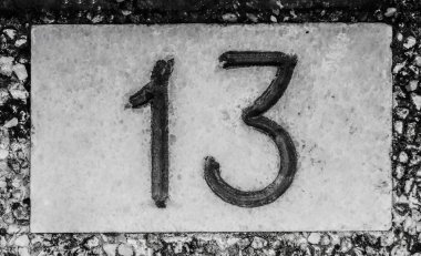 number  written in white on a black and white square plate. Numerical sign fixed at a house exterior wall to indicate the address in street. Vintage design image clipart