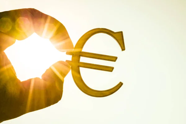 Iemands Hand Met Euro Pictogram Silhouet Tegen Zonnige Blauwe Gele — Stockfoto