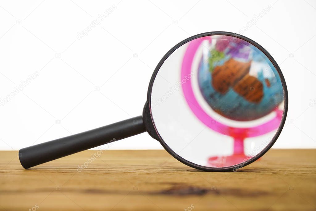 Travel And Adventure.  globe in Magnifying Glass