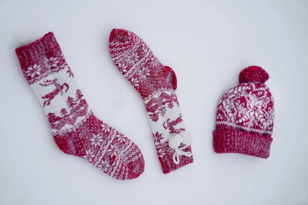 Two Christmas Socks One Red Knitted Hat Snow Background — Stock Photo, Image