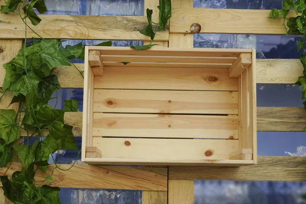 Top view of  empty wooden box  hanging  on wall.