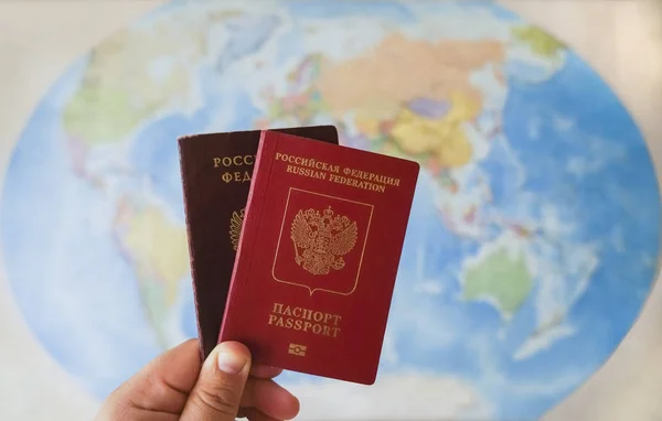 two Russian passports for traveling abroad  on the world map background