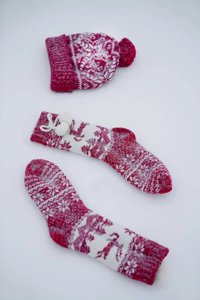 Two Christmas Socks One Red Knitted Hat Snow Background — Stock Photo, Image