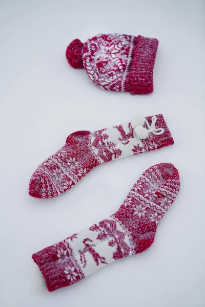 Two Christmas Socks One Red Knitted Hat Snow Background — Stock Photo, Image