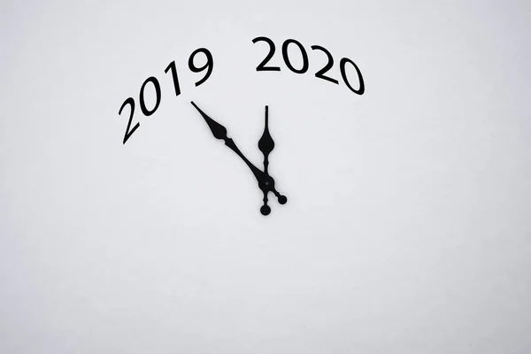 hands of the clock between 2019 and 2020 new year